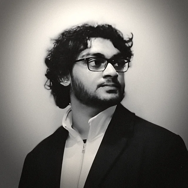 B. Harshavardhan Varma in a dark jacket